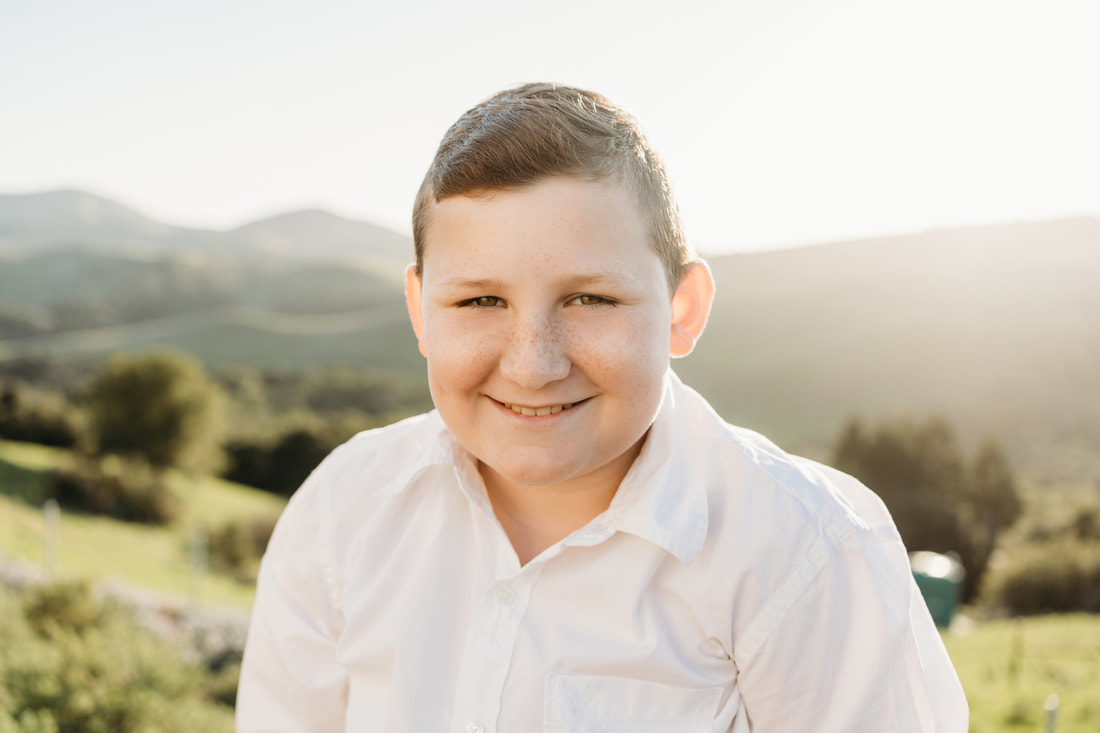 A classic white button down shirt is always a good choice for boys portraits.