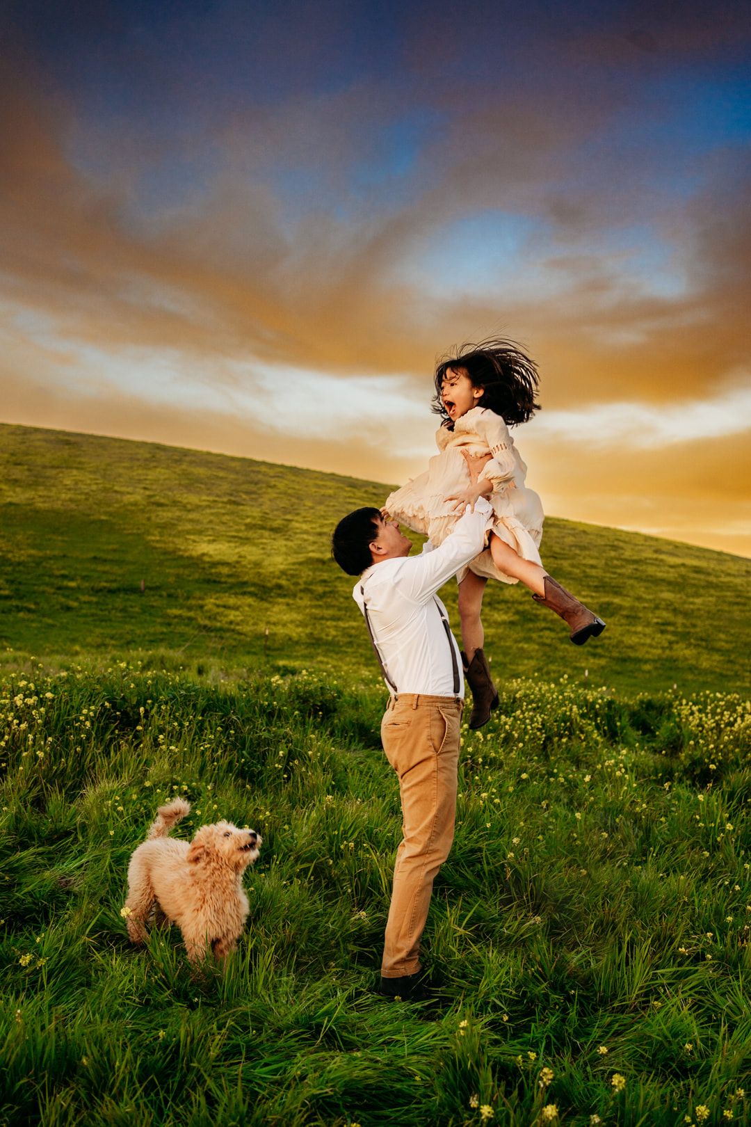 A father throws his young daughter in the air during their photoshoot in Pleasanton CA.