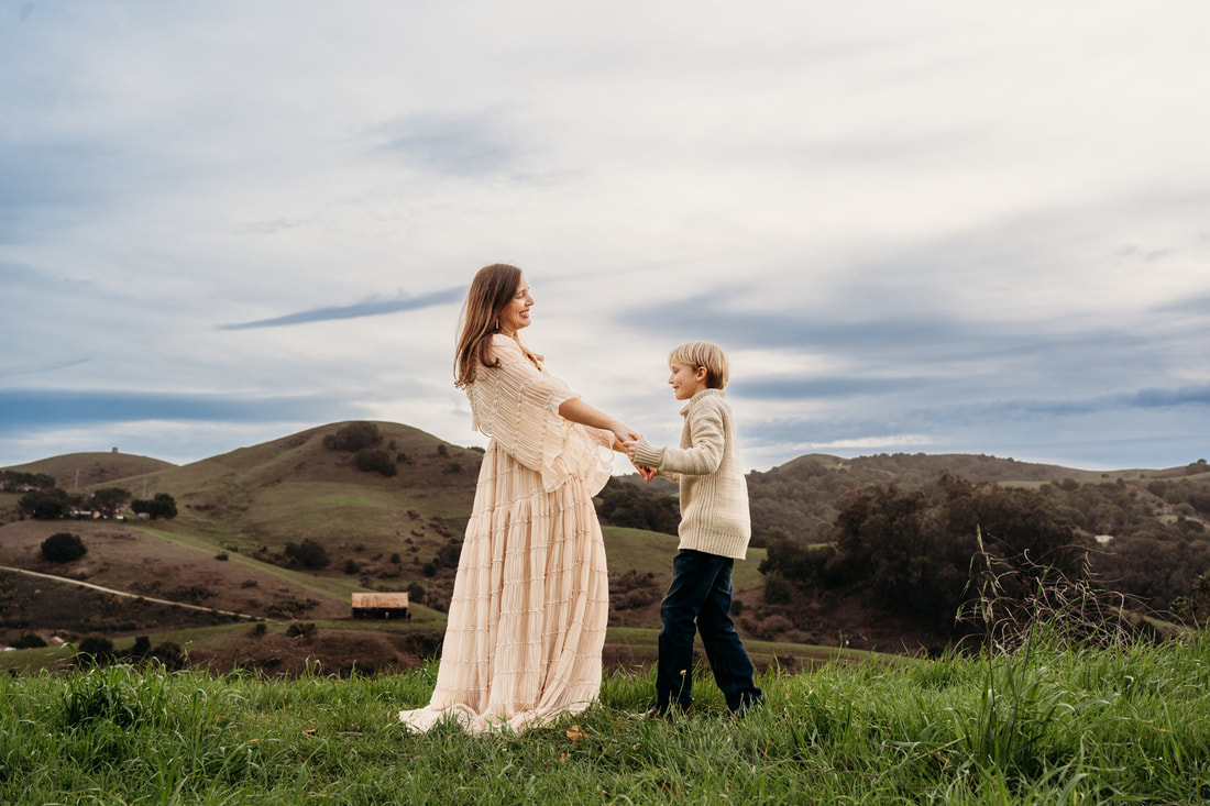 A mother and son dance during their Pleasanton family photoshoot.